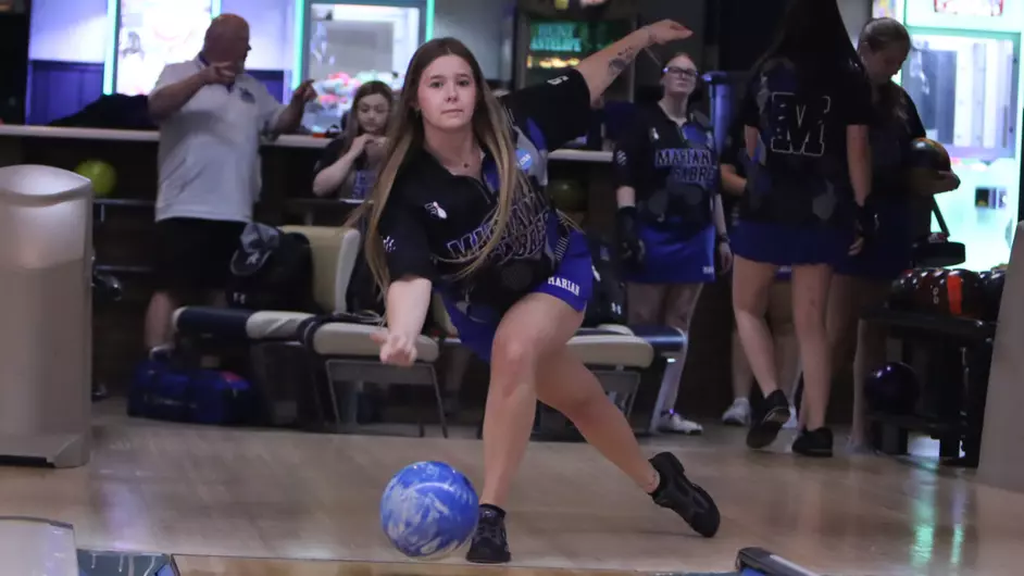 A woman bowling on her college team