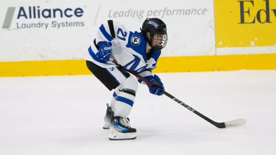 A woman playing college hockey