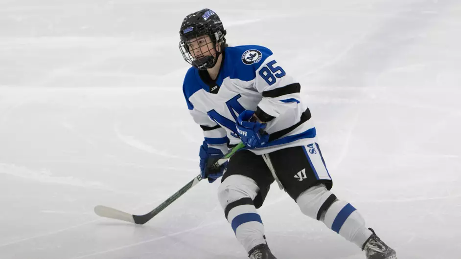 A woman playing college hockey