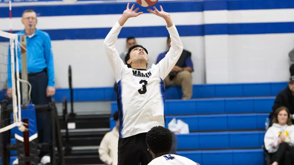 Men playing college volleyball