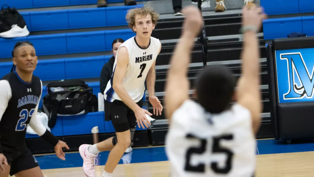 Men playing college volleyball