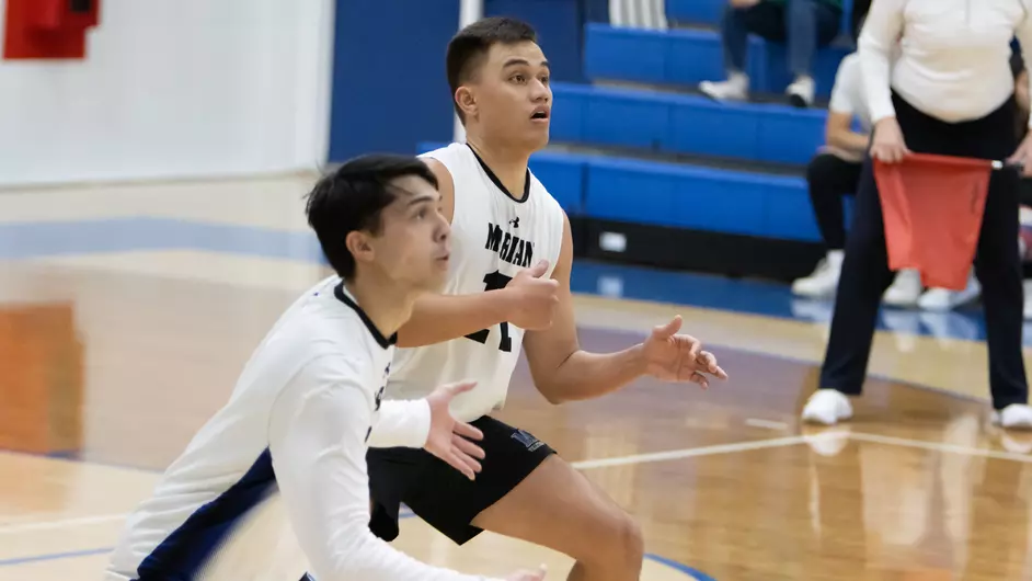Men playing college volleyball