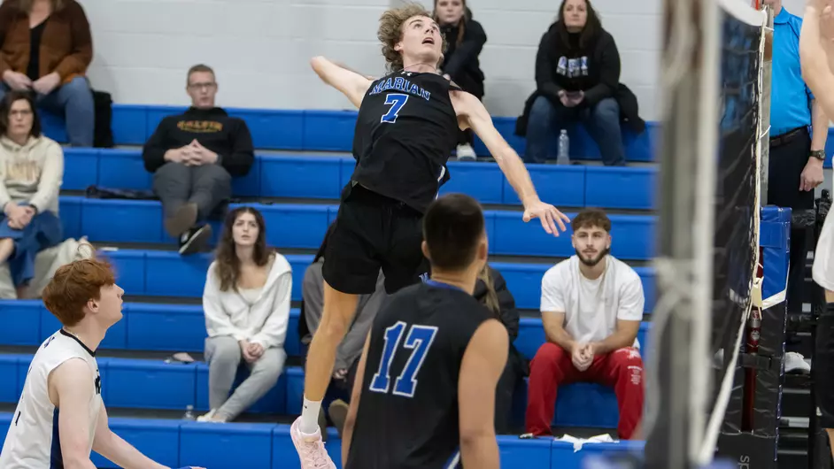 Men playing college volleyball