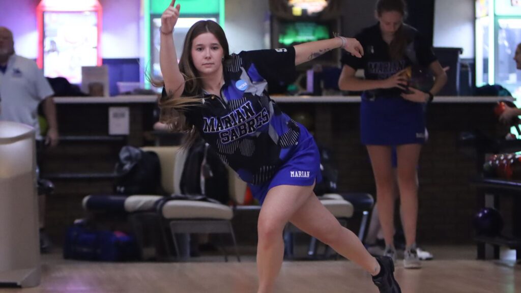 A woman bowling for her college team