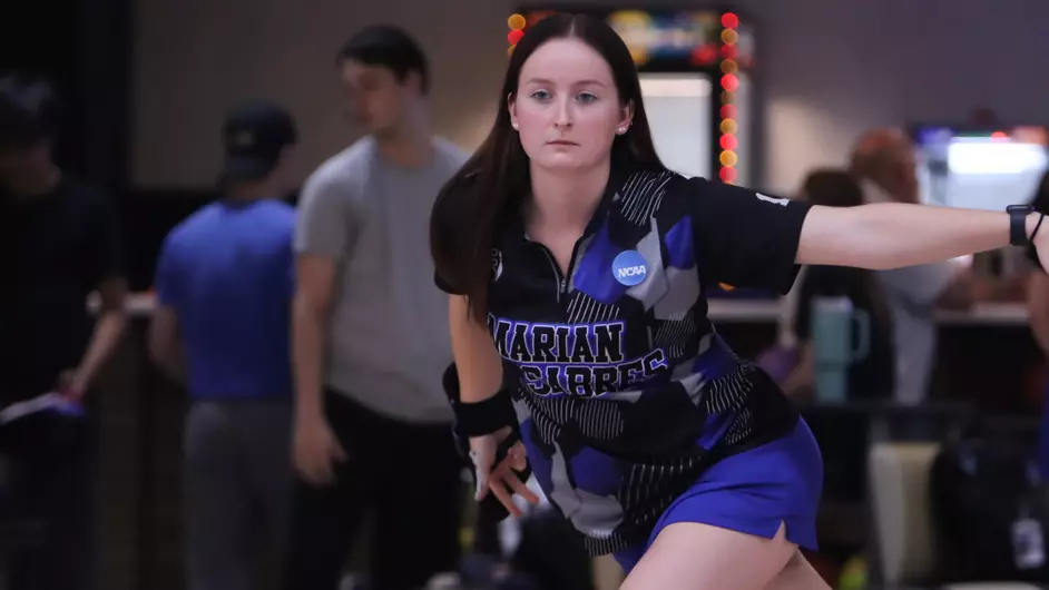 A woman bowling for her college team