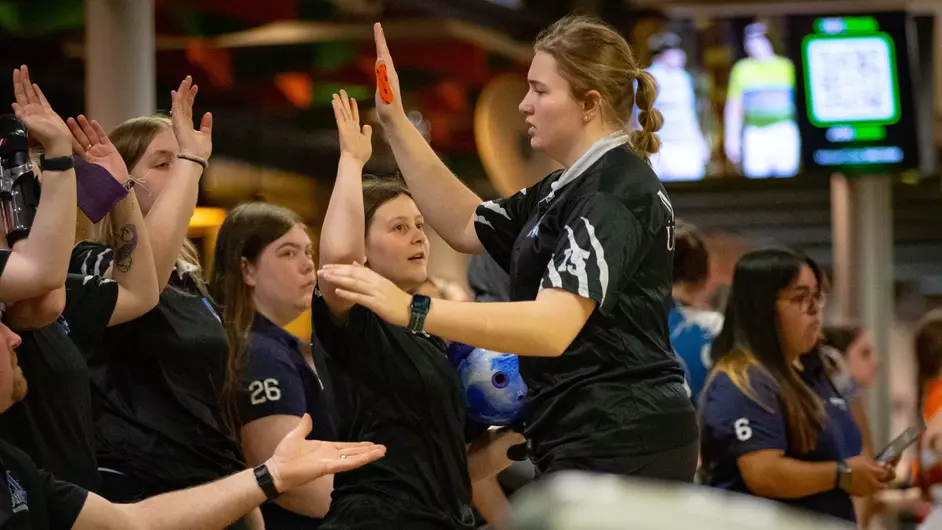 College female bowlers high fiving
