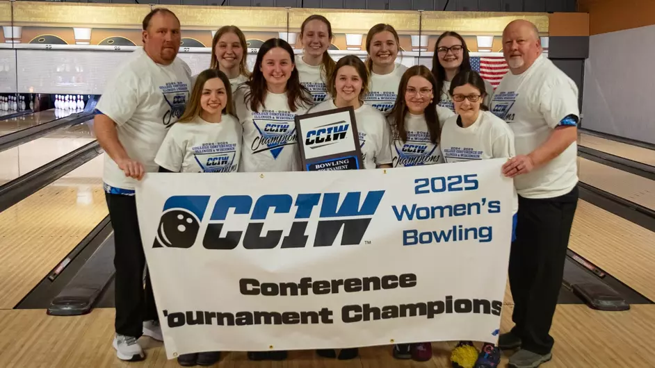 A group of female college bowlers with their coach and a banner