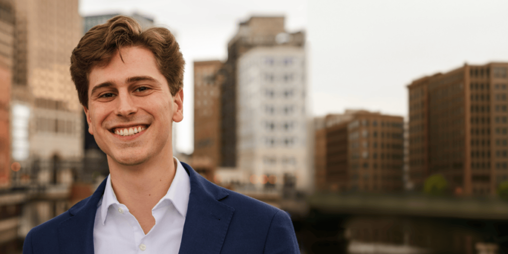 A smiling young man outside