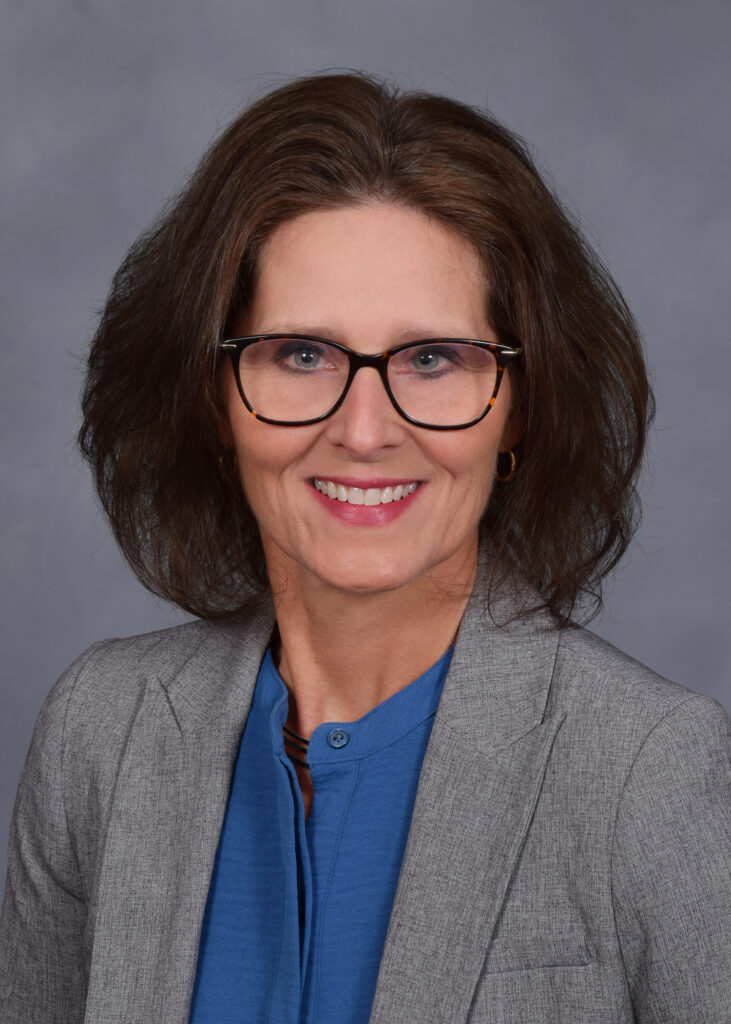 A smiling woman with glasses