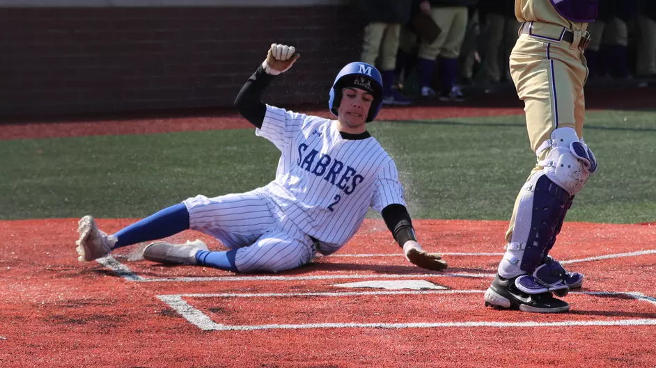 A college baseball player sliding home