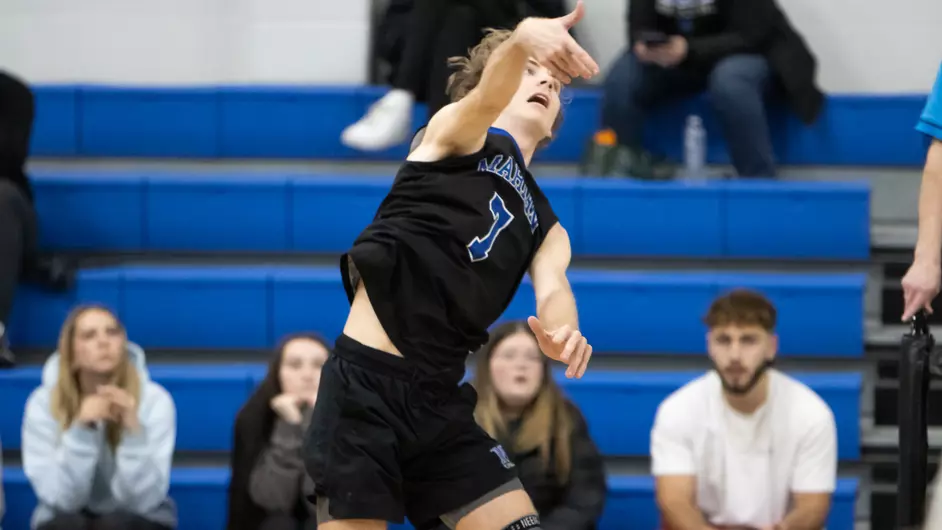 Men playing college volleyball