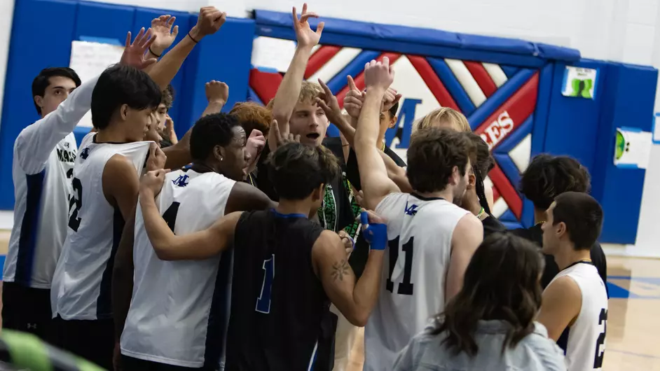 Men playing college volleyball