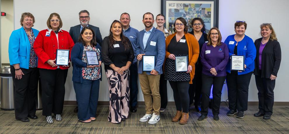 A large group of people holding certificates