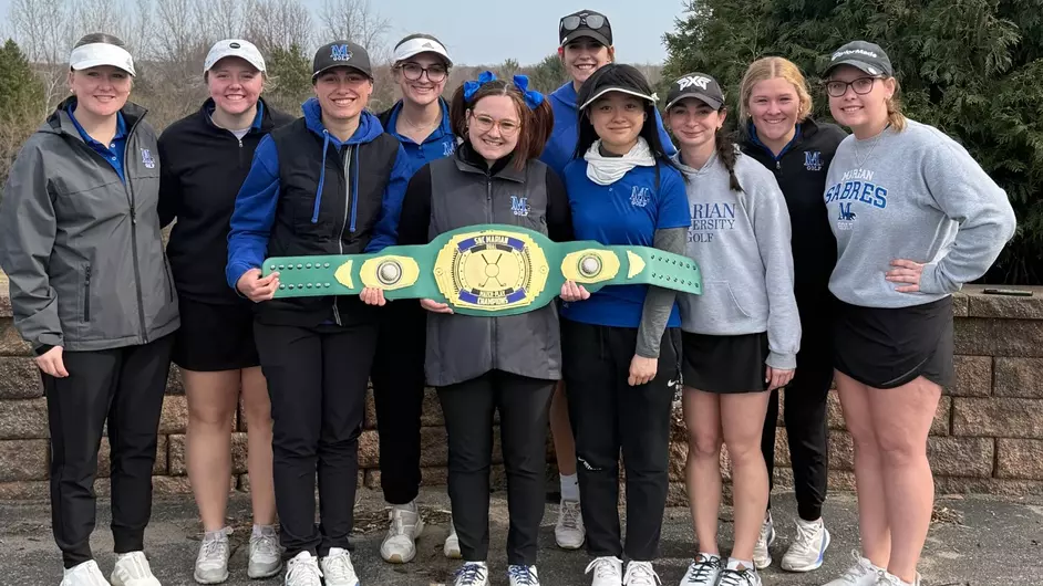 A college womens golf team holding a championship belt