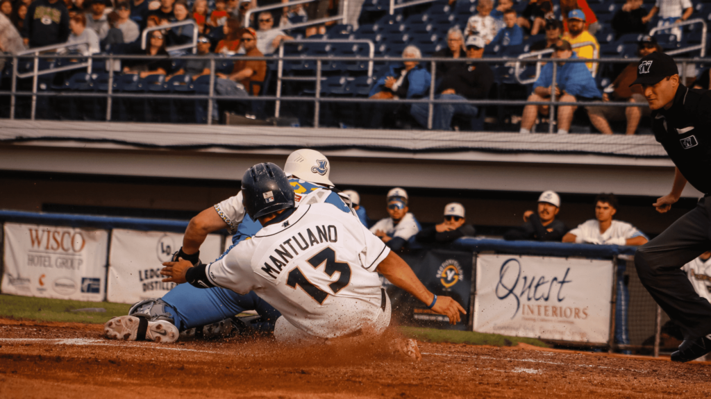 A baseball player sliding into base.