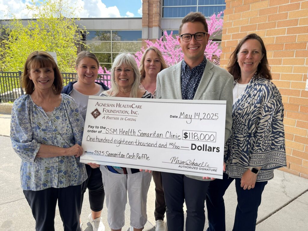 A group outside with a big check