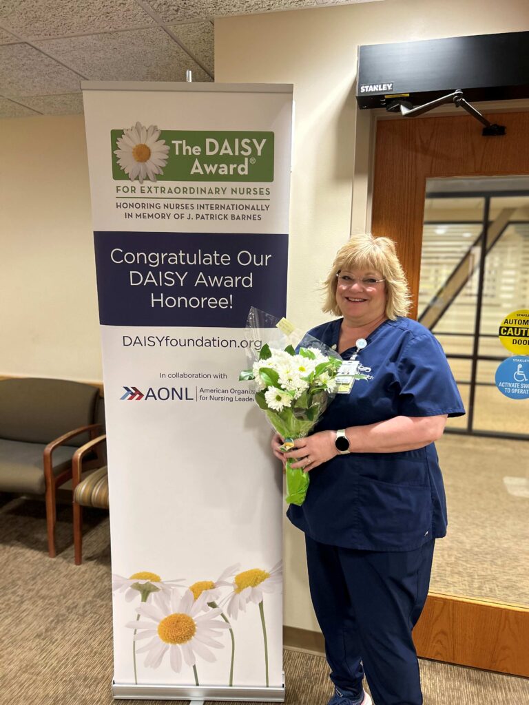 A nurse holding a bouquet of flowers