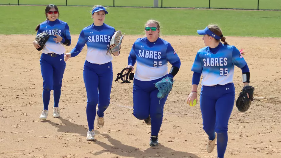 Four female college softball players