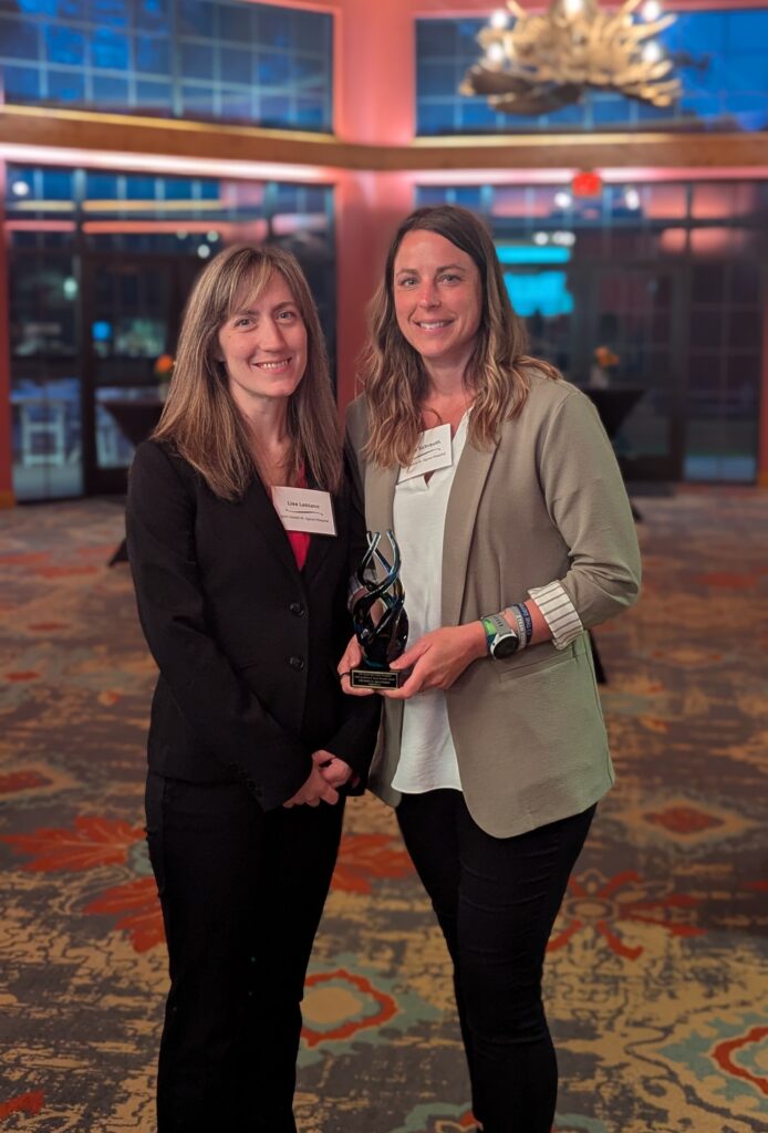 Two women holding a trophy