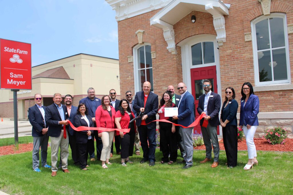 A large group outside for a ribbon cutting