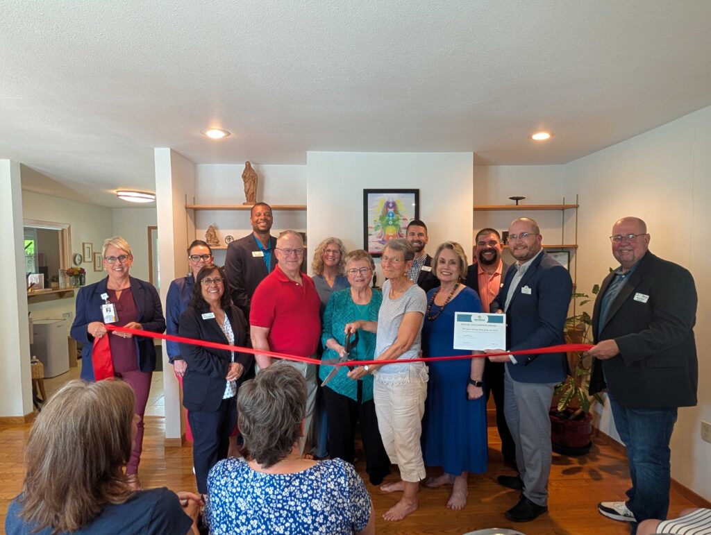 A large group of people inside for a ribbon cutting