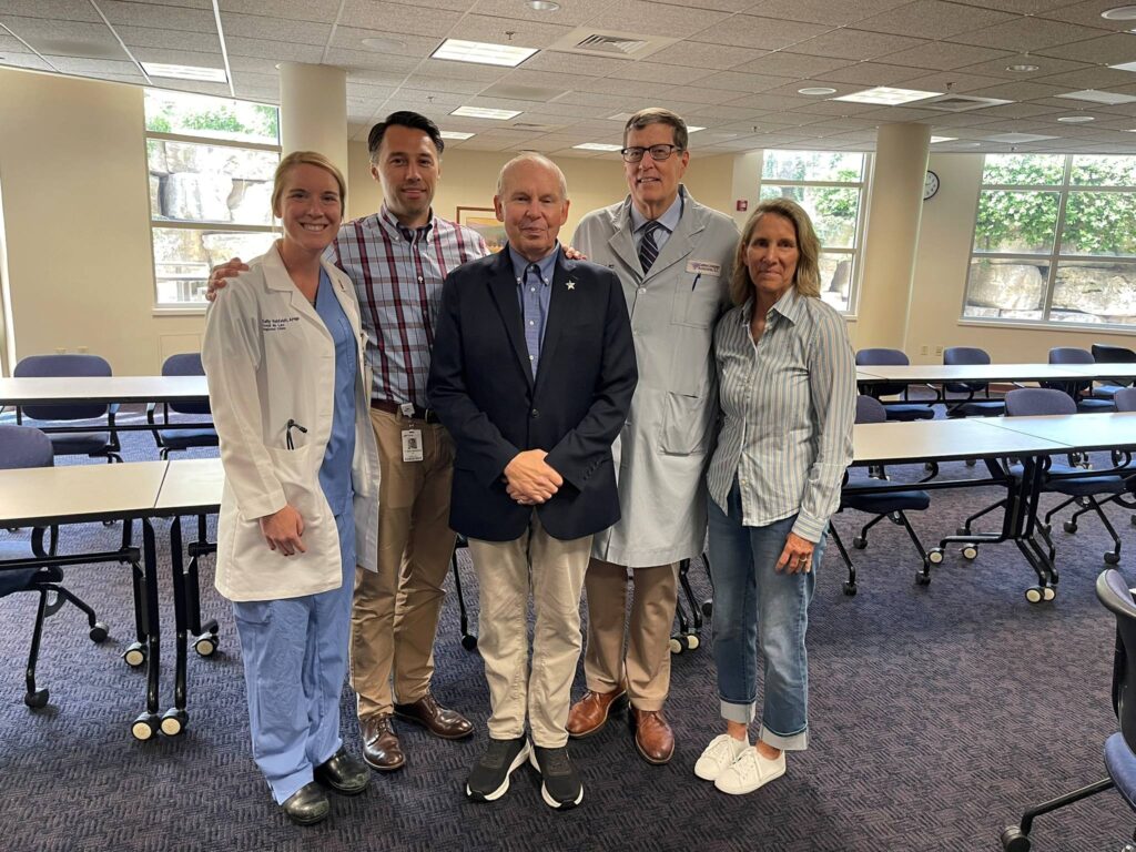 A group of five people standing in a hospital