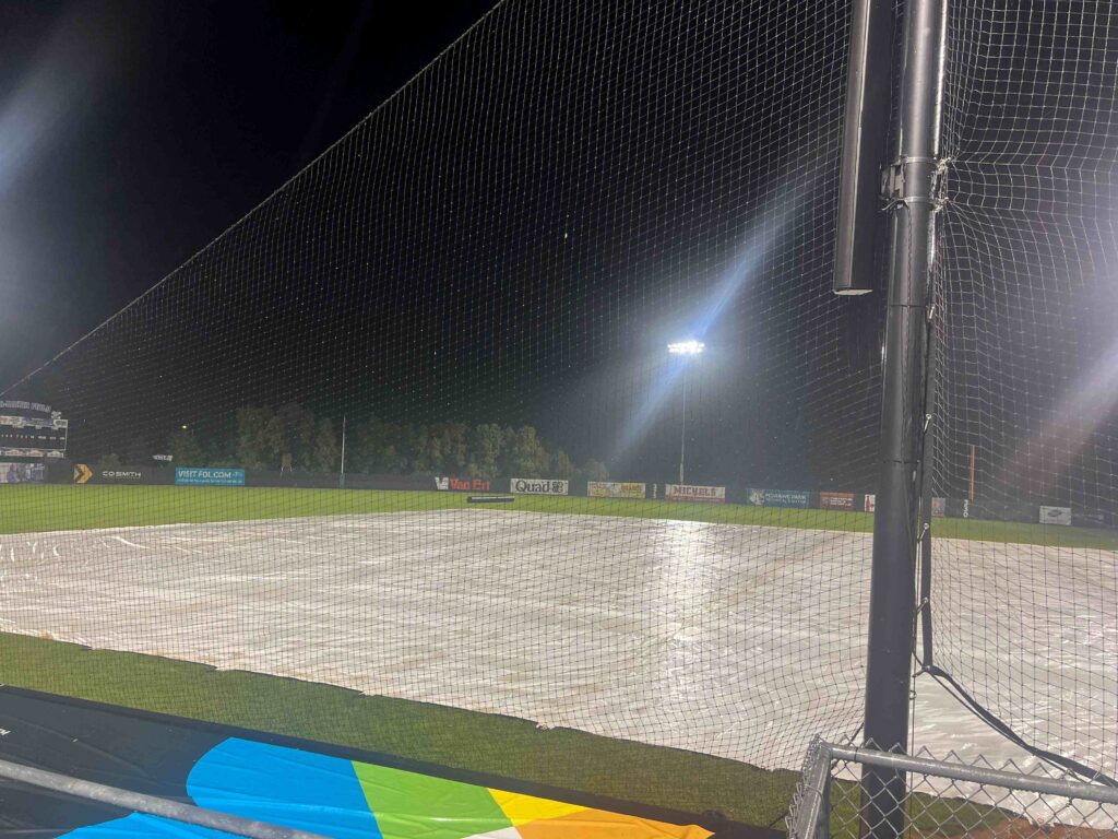 Rain soaked tarp on a baseball field
