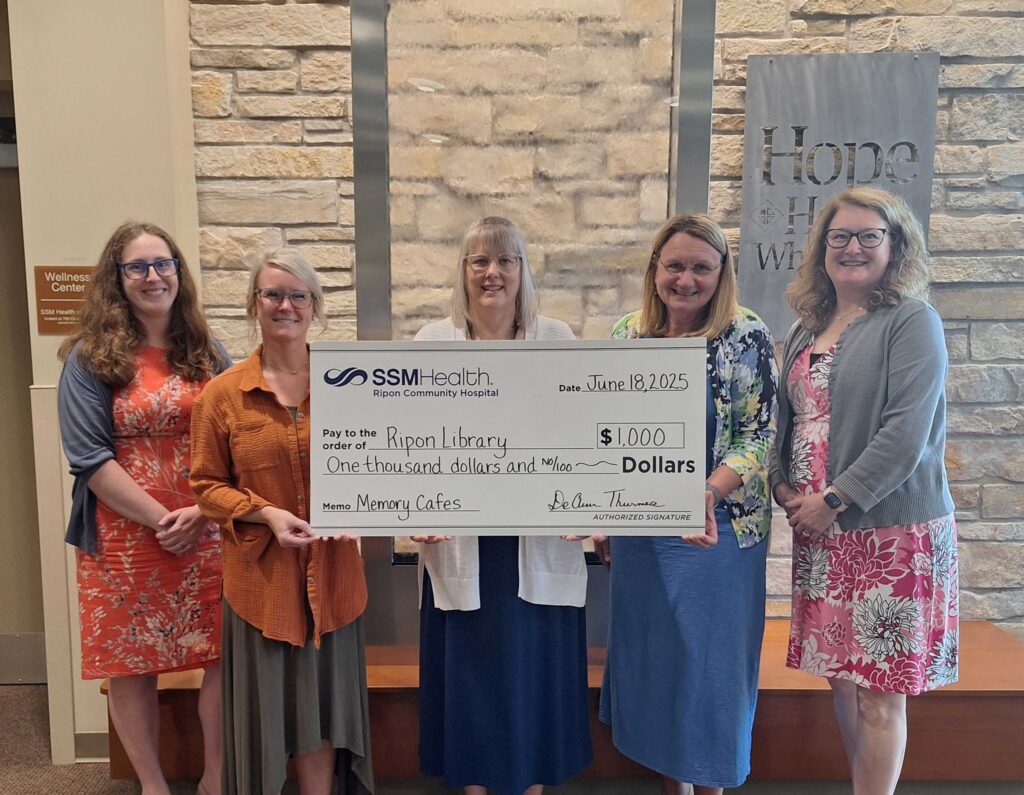 Five women holding a big check