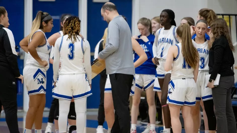 A group of women playing basketball