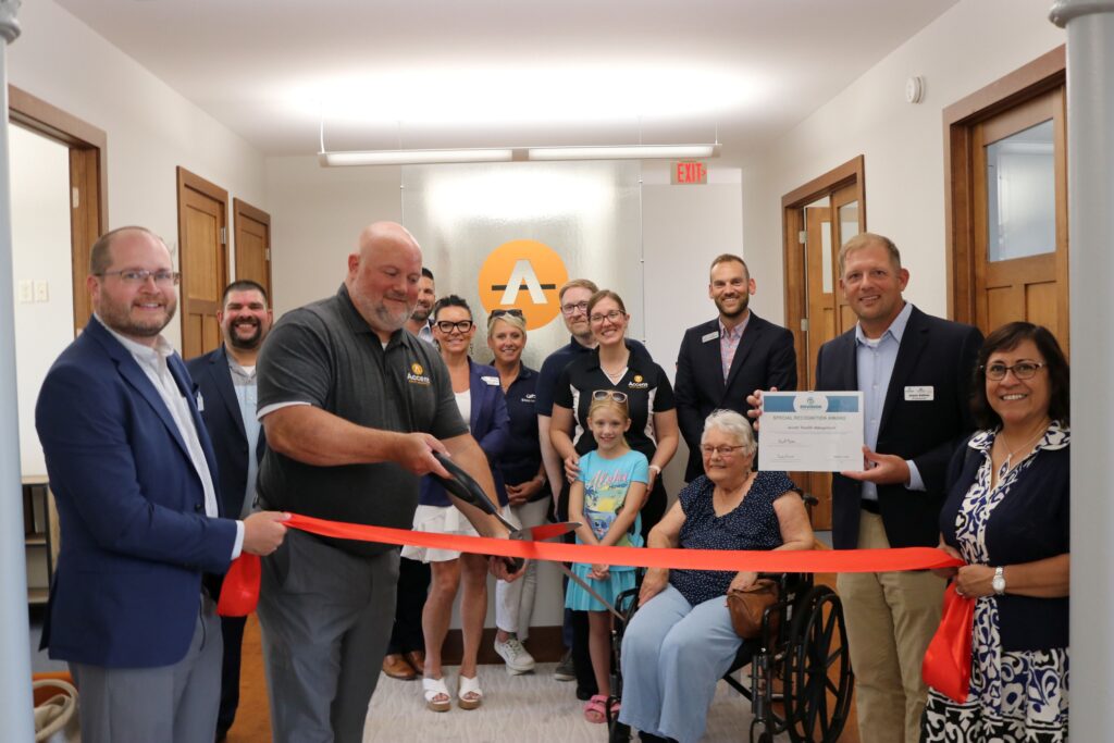 A large group inside for a ribbon cutting
