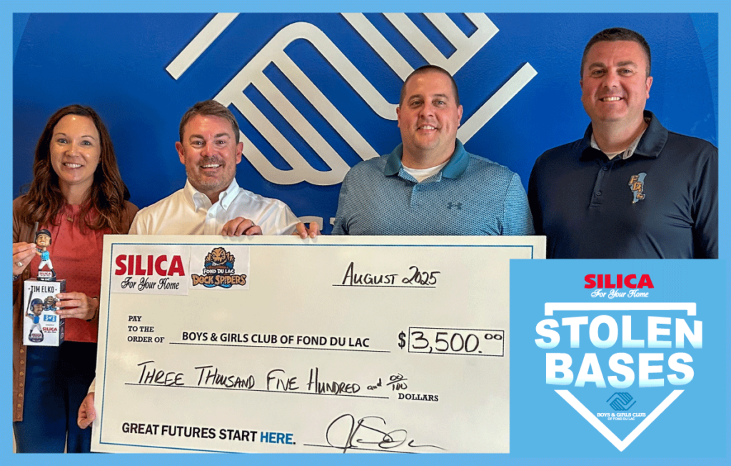 Four people with a big check
