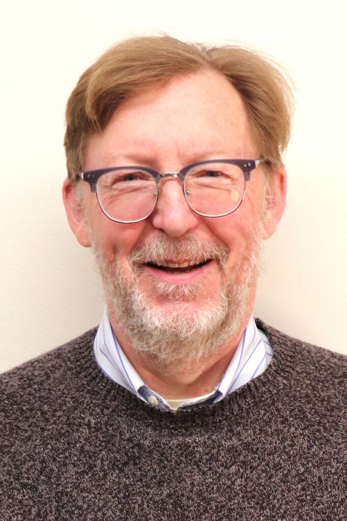 An older gentleman in a sweater