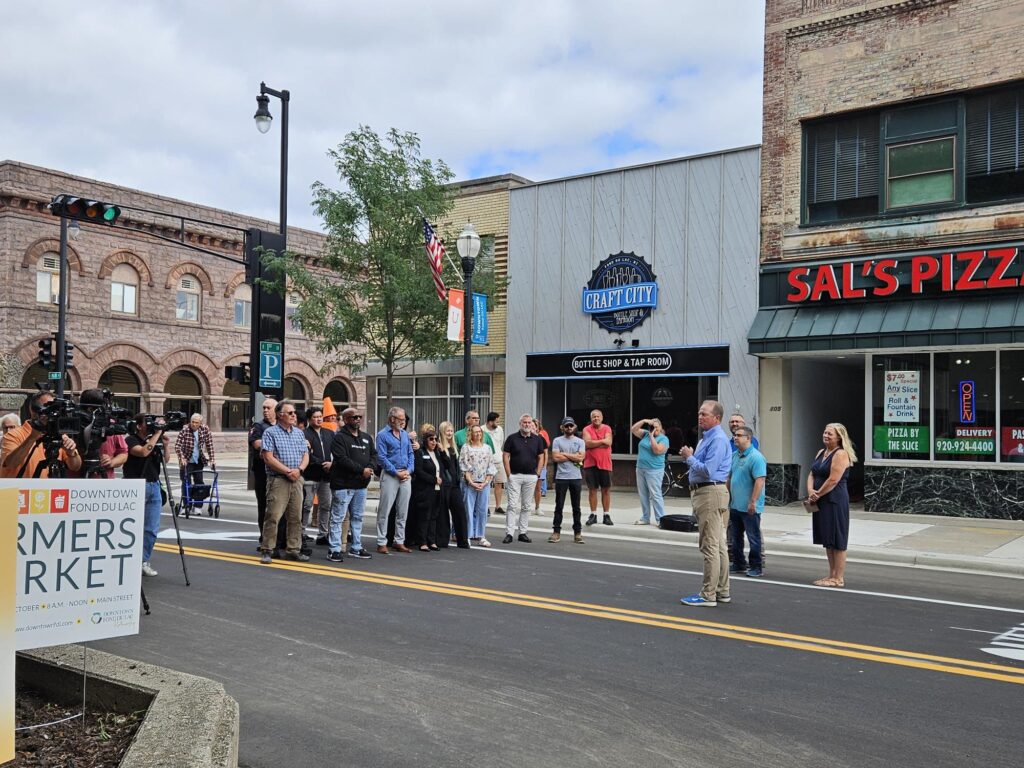 A group gathered outside on the street