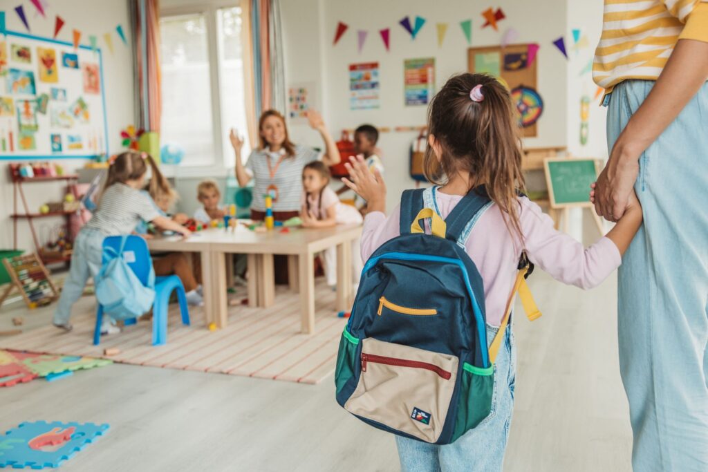A young girl walking into day care
