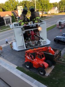 Two firefighters in a lift