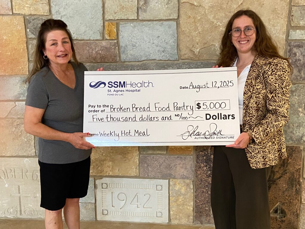 Two women with a big check