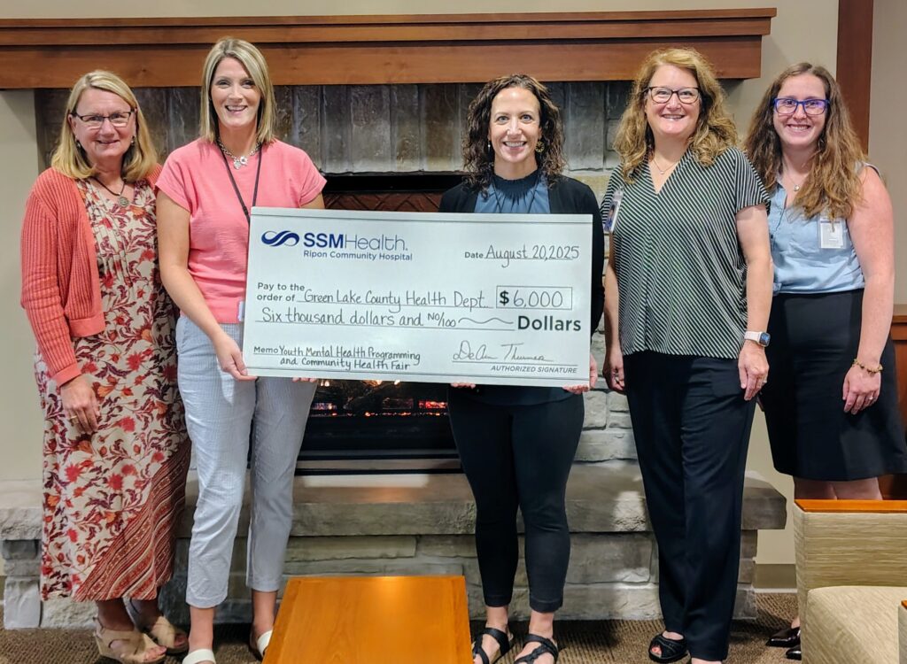 Five women holding a big check