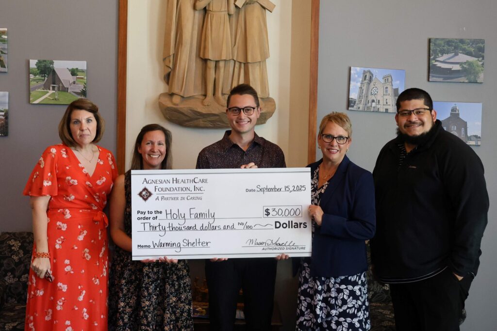Five people holding a big check