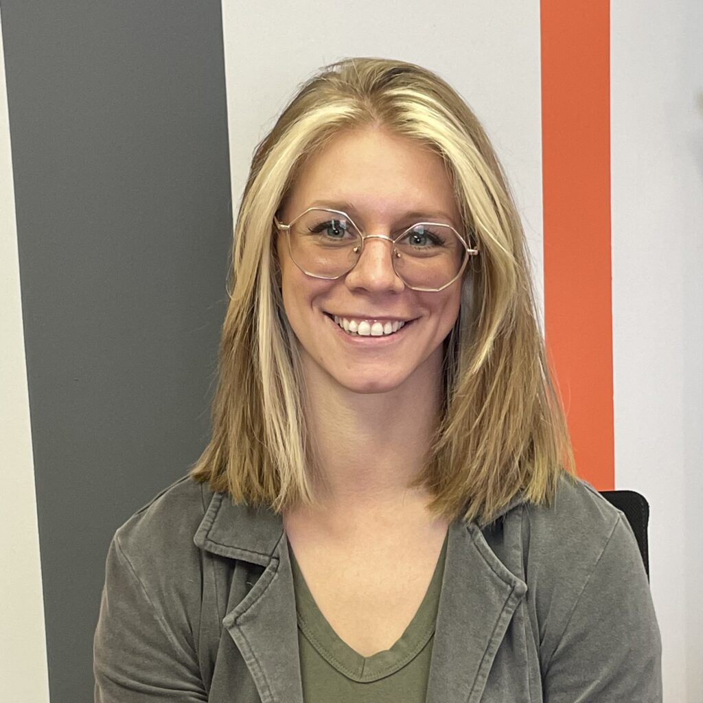 A smiling woman wearing glasses