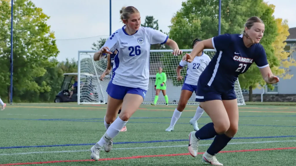women playing college soccer