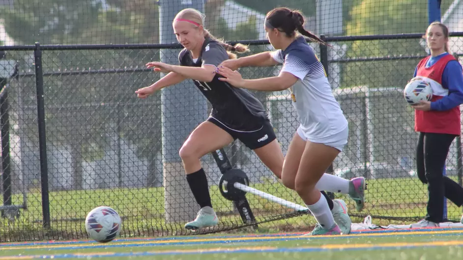Women playing college soccer