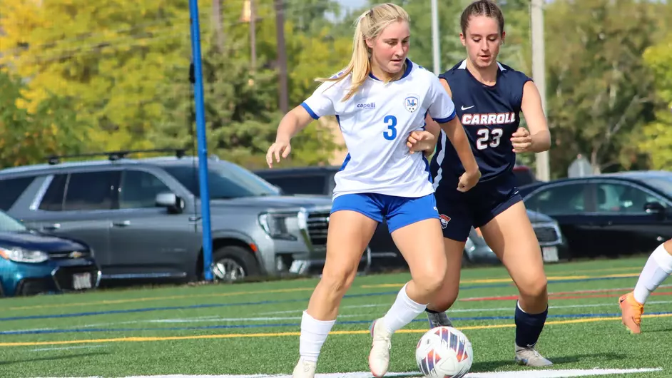 Women playing college soccer