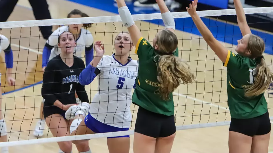 Women playing college volleyball