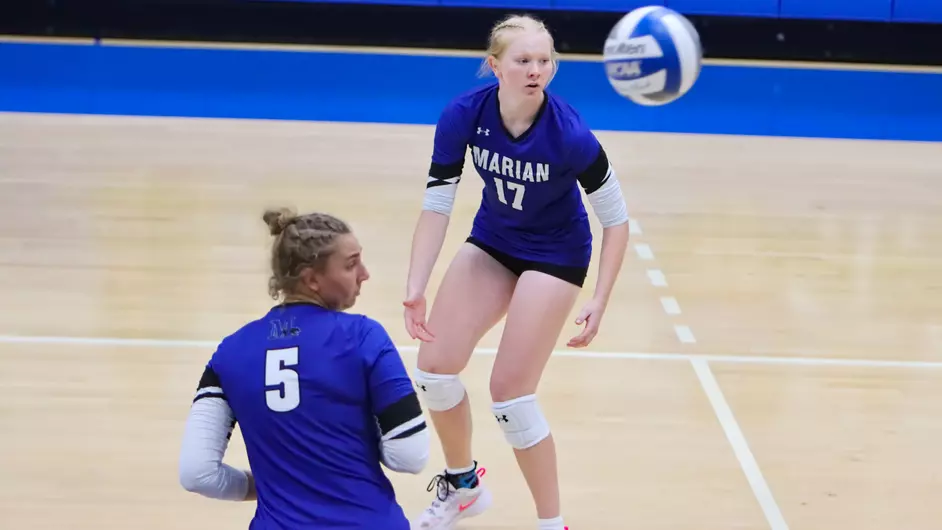 Women playing college volleyball