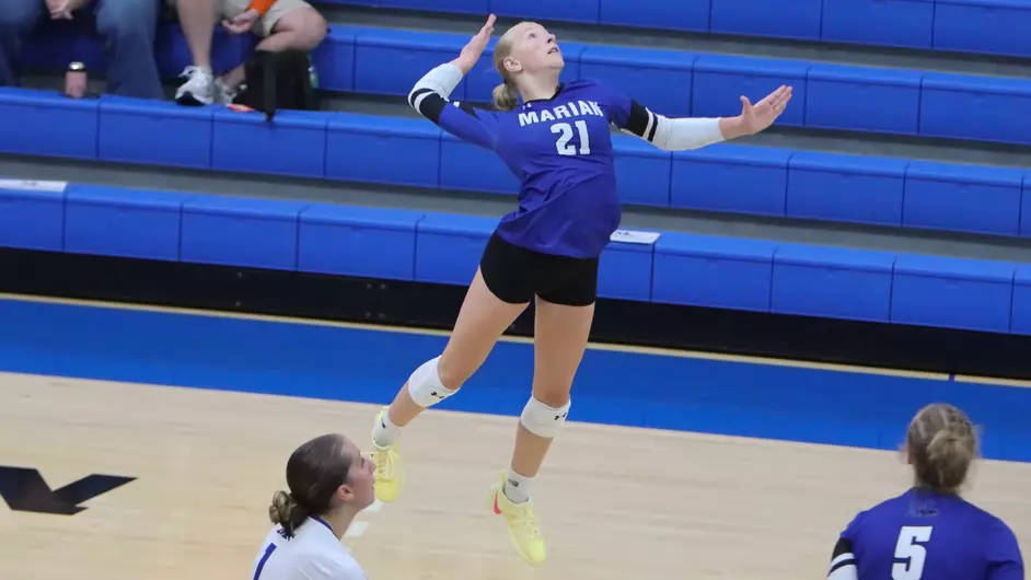 Women playing college volleyball