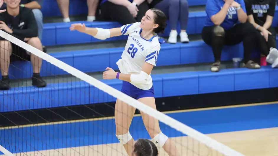 Women playing college volleyball