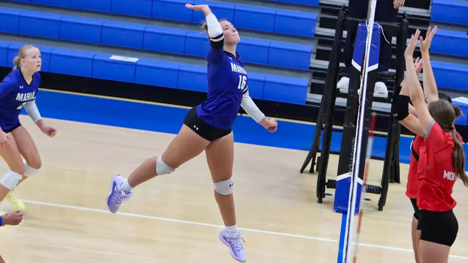 Women playing college volleyball