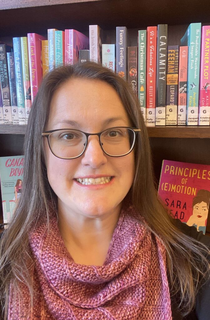 A young woman in front of a bookcase