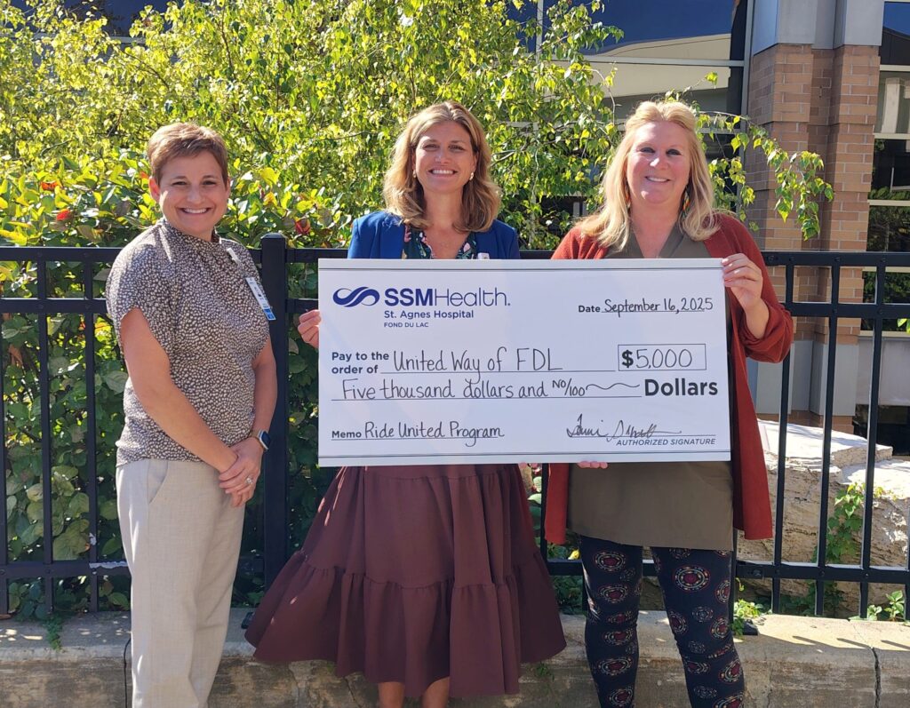 three people and a big check