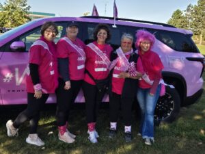 Five women next to a car